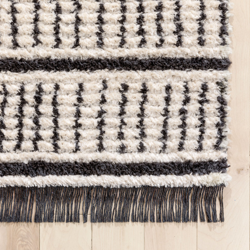Ivory and Black Geometric Synthetic 4' x 6' Area Rug