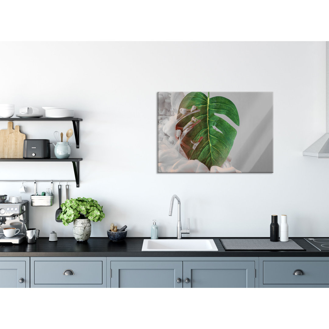 Glasbild Monstera Blatt mit Pastellwolke