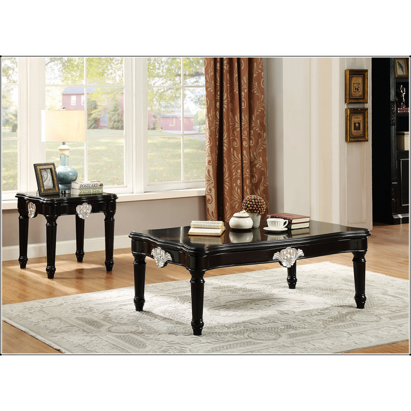 Élégante table basse noire avec pieds tournés, alliant élégance et durabilité pour les espaces de vie modernes.