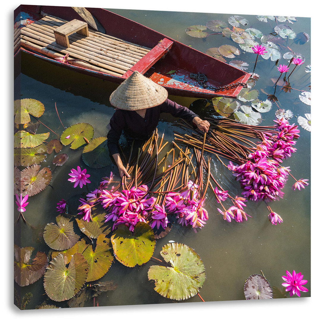 Leinwandbild Seerosenernte mit Boot in Vietnam