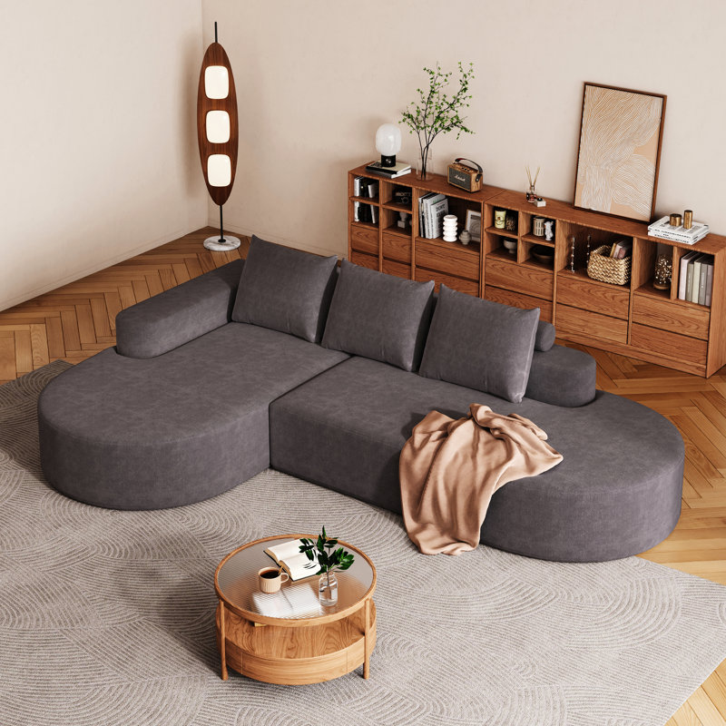 Élégant canapé arrondi en chenille haute résilience et assise très large pour une détente confortable