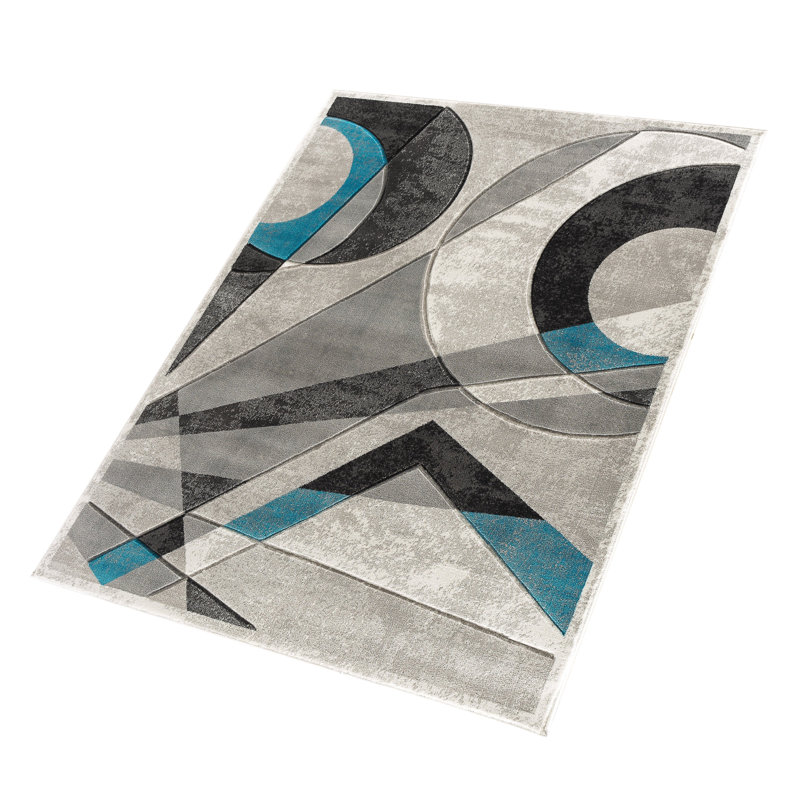 Tapis rectangulaire 9x12 turquoise aux motifs géométriques sculptés à la main, en polyester doux à poils courts, pour salon ou chambre.