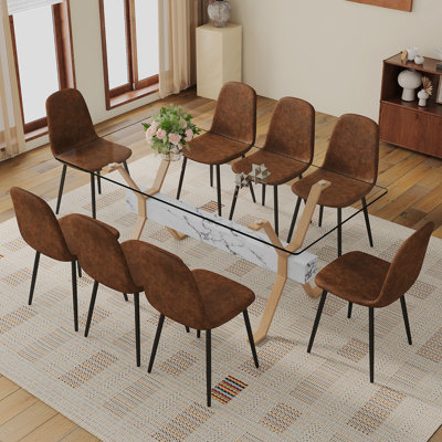 Ensemble de table et de chaises. Table de salle à manger élégante en verre trempé transparent - 71 po x 35,4 po avec 8 chaises en tissu brun et technologie avec pieds en métal noir. Grande table avec pieds en métal en forme de X.