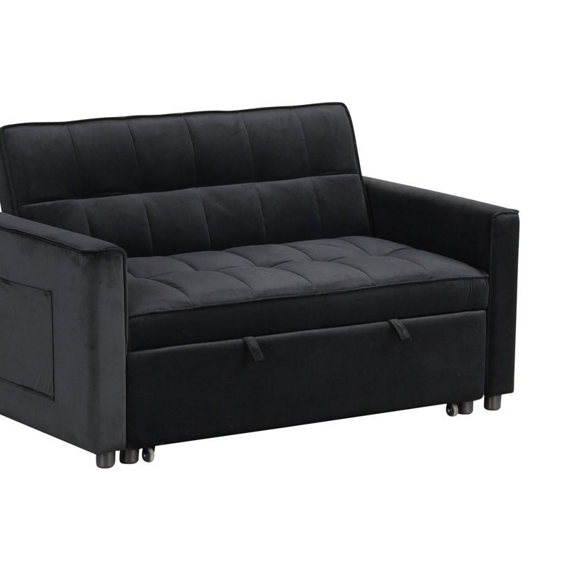 Causeuse-lit convertible Maia avec revêtement en velours, conception capitonnée et poches latérales intégrées pour une double fonctionnalité.