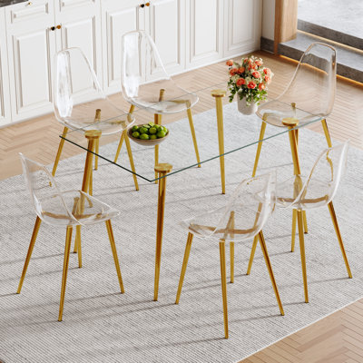 Table de salle à manger en verre trempé avec 6 chaises en plastique transparent et pieds dorés -, stable, luxueuse surface lisse en métal moderne, sécuritaire, assemblage rapide