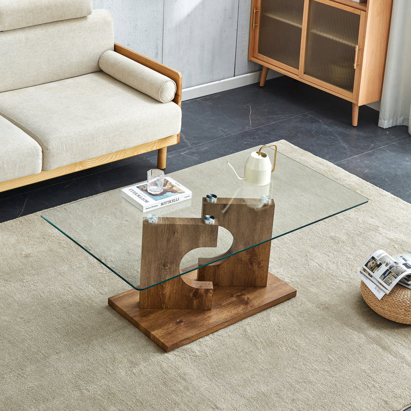 Une table basse rectangulaire moderne et tendance avec plateau en verre trempé et pieds en panneau de fibres à densité moyenne. Convient au salon: 47,2 po x 25,5 po x 18 po