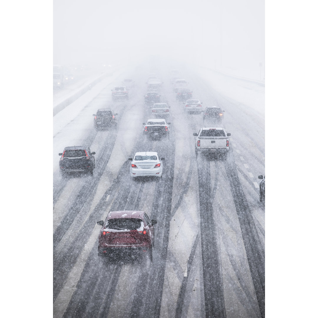 Cars Driving On A Snow Covered Road von Pgiam - Ohne Rahmen auf Leinwand drucken