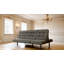 Canapé futon gris foncé avec capitonnage biscuit et appui-tête réglable, convertible en méridienne ou en lit pour un confort polyvalent