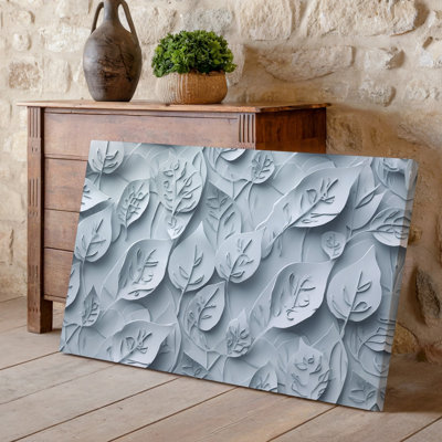 La toile crée un motif sans couture avec des formes de feuilles stylisées qui se chevauchent dans l'art mural