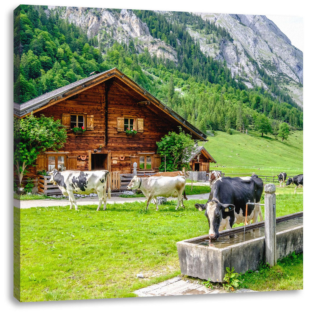 Leinwandbild Kühe vor Blochhütte auf der Alm