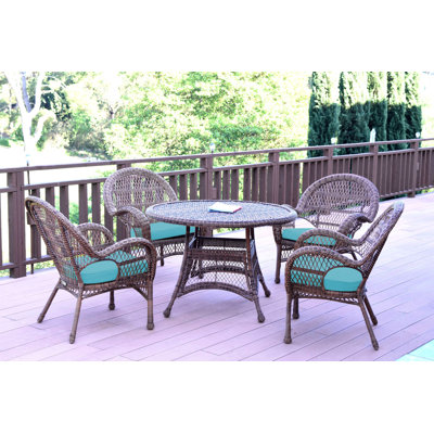 Mangum 4 - Person Wicker Patio Dining Set with Round Table
