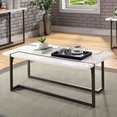 Table basse moderne de style contemporain avec pieds extensibles, plateau en laque ultrabrillante et structure en acier au fini blanc et bronze