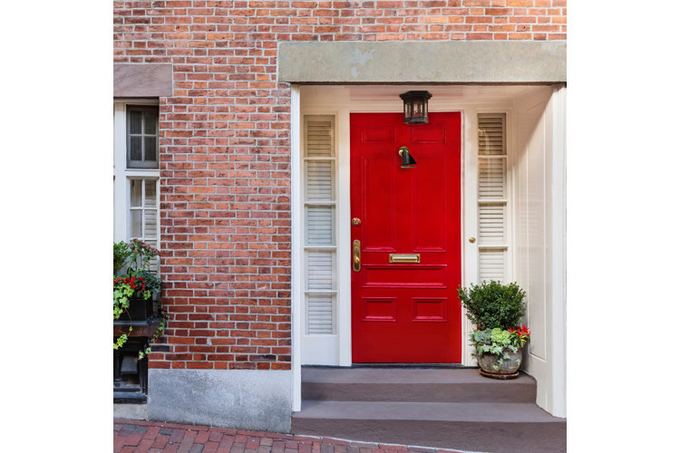 front door with sailboat door knocker and gold hardware