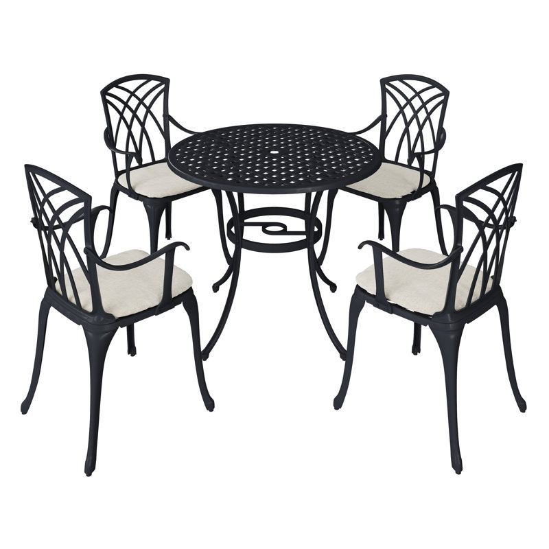 Josiah 4 - Person Patio Dining Set with Round Table , Cushions Included