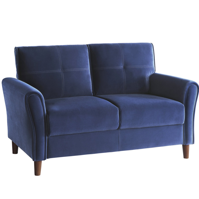 Salon confortable en velours bleu avec siège évasé, accoudoirs et housses de coussin amovibles