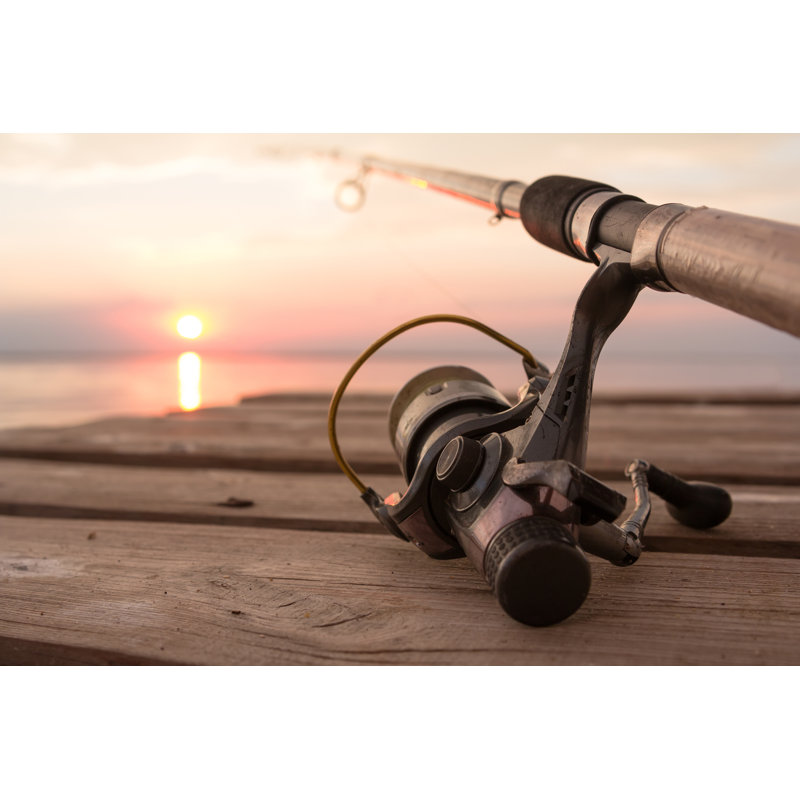 Fishing Reel And Rod Lying On Wooden Pier Over by Helios8 - Wrapped Canvas Print, 61cm H x 91cm W x 3.8cm D	
