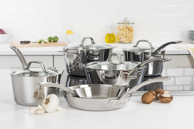stainless steel induction cookware set on a smooth stovetop