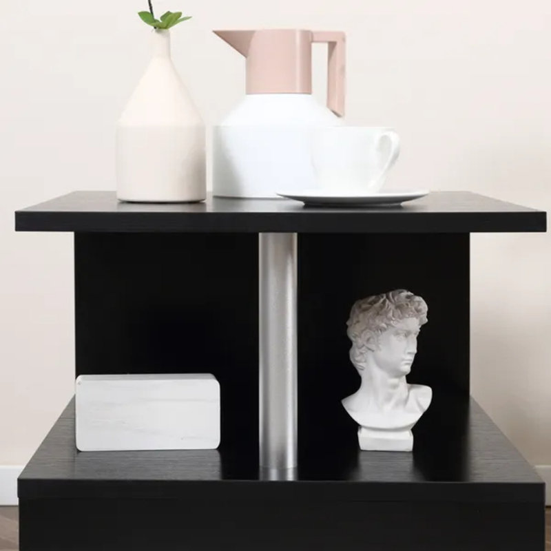 Table basse noire avec plateau relevable et en forme de S
