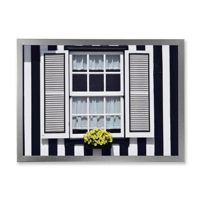 " Window With Yellow Flower On Striped House "