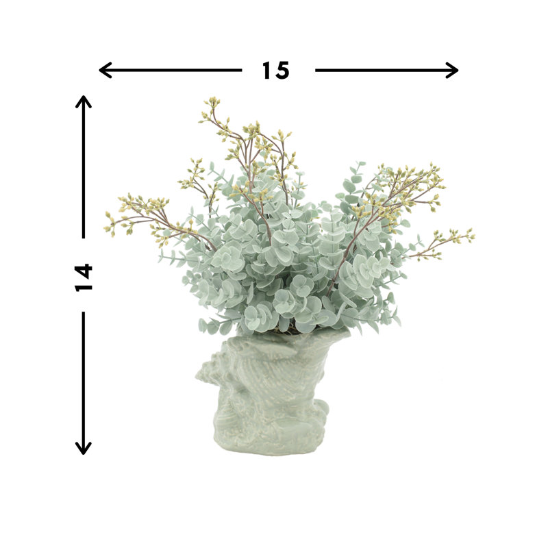 Eucalyptus Arrangement In A Shell Vase.