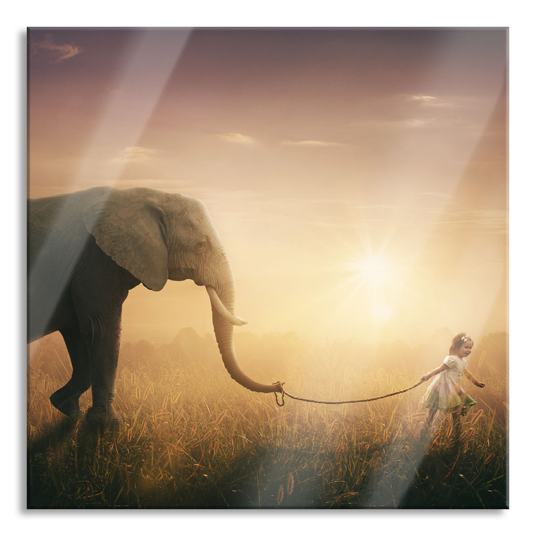 Glasbild Kind und Elefant bei Sonnenuntergang