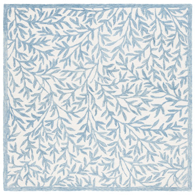 Iqarar Hand Tufted Wool/Cotton Floral Rug in Blue/Ivory