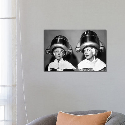 1950s Two Women Sitting Together Gossiping Under Hairdresser Hair Dryer by Vintage Images - Wrapped Canvas Print