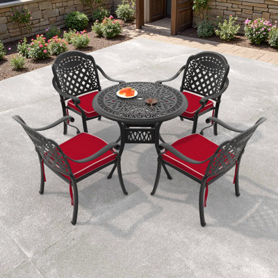  Ensemble repas pour 4 personnes avec table ronde Sergias Sergias, coussins rouges inclus