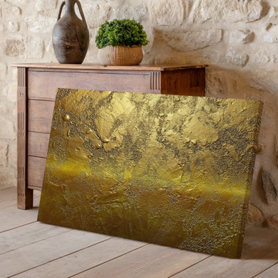 Toile, surface richement texturée en or scintillant avec un dégradé subtil qui transite d'une teinte dorée chaleureuse