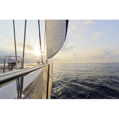 " Yacht Sailing At Sunset " by Photurist