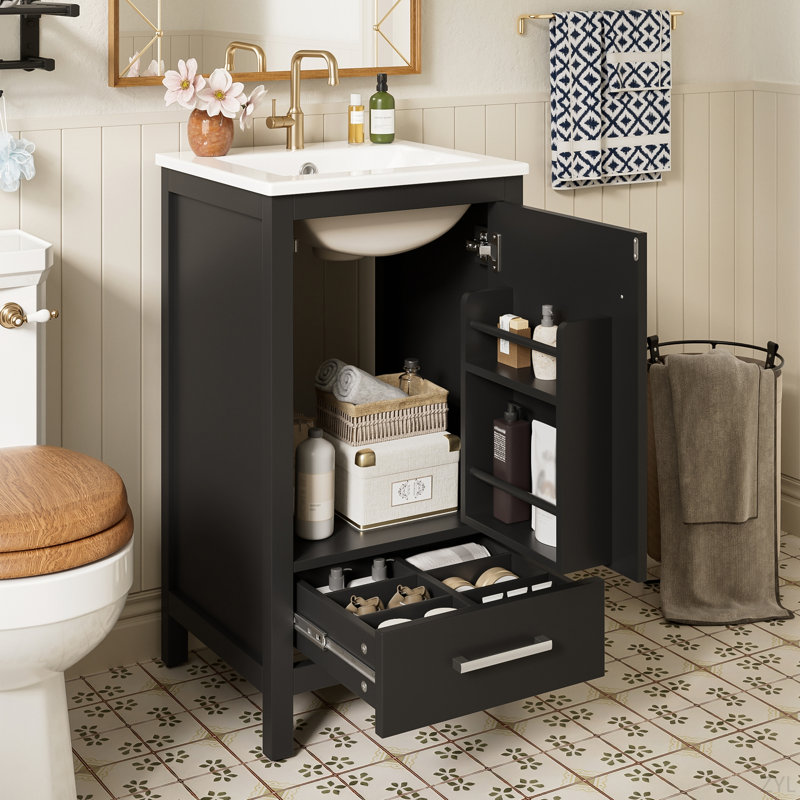 Meuble-lavabo moderne de 18 pouces avec lavabo en céramique, tiroirs à fermeture en douceur et organisateur de porte, tiroir de séparation et patins réglables en plastique - solution de rangement compacte pour les espaces étroits.