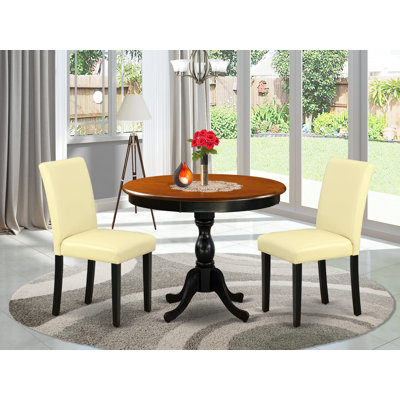 L'ensemble de table de cuisine 3 pièces comprend une table de salle à manger ronde avec piédestal et 2 chaises de salle à manger Parson
