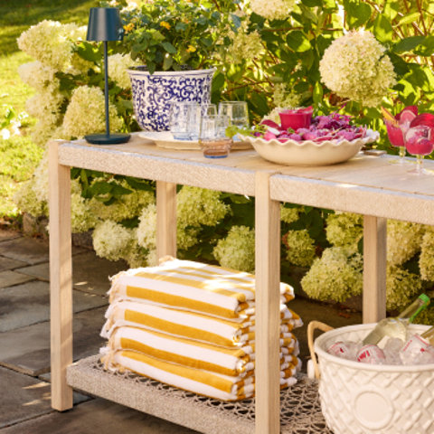 Outdoor entertaining table with drinks and towels