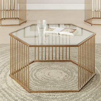 Table basse en champagne et verre transparent