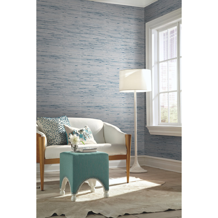 The textured blue grasscloth wallpaper and ropeframed mirror give off a  beachy   Sorenti Properties