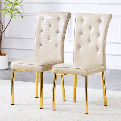 Un ensemble de 4 chaises de salle à manger vintage en cuir de crocodile rembourrées, ornées de fermoirs en cristal et revêtues de simili cuir, apportant une touche d'élégance et de mystère à votre salle à manger.