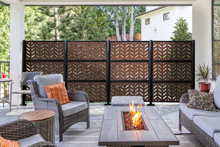 outdoor covered patio area with a conversation set shielded by a modern privacy wall
