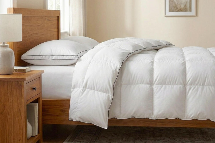 white down comforter on wooden bed in neutral bedroom