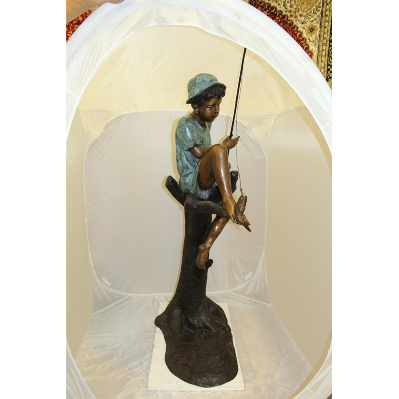 Boy Sitting on a Tree and Fishing Bronze Statue -  Size: 34"L x 28"W x 64"H. 