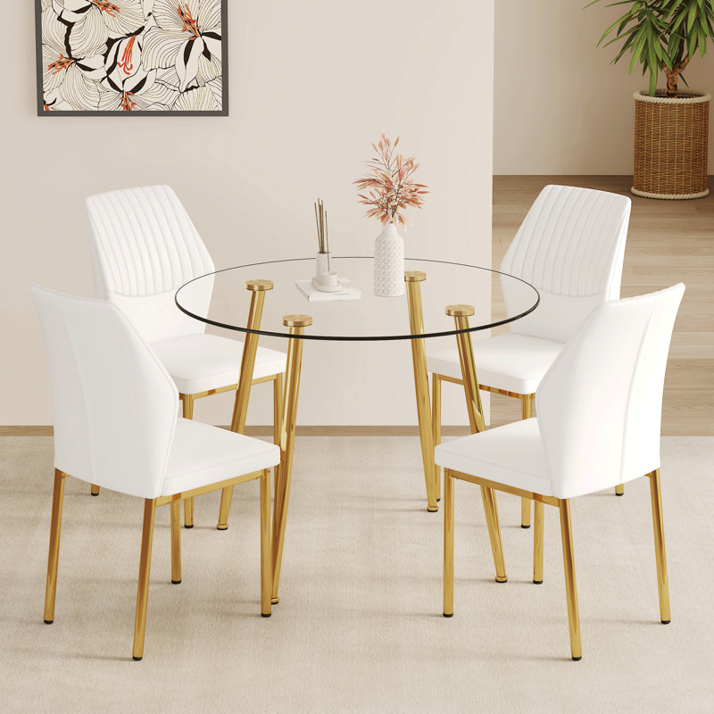Ensemble de salle à manger luxueux en verre moderne avec cadre en métal doré parfait pour les espaces élégants