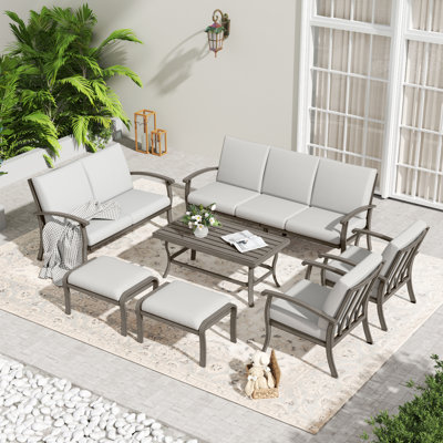 7-Piece Aluminum Patio Conversation Set With Coffee Table, End Table, Ottomans And Light Gray Cushions