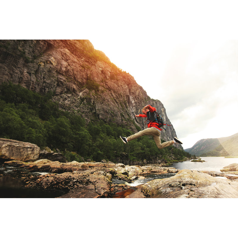 Man Jumps Over River by LeonidKos - Wrapped Canvas Print, 30cm H x 46cm W