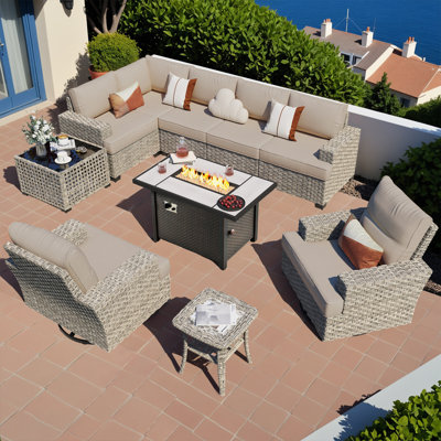7- Person Rattan Outdoor Seating Group With Swivel Rockers and Fire Pit Table