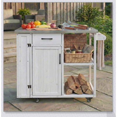 Îlot de cuisine extérieure avec plateau en acier inoxydable et beaucoup de rangement, idéal pour la préparation des repas et les grillades sur la terrasse.