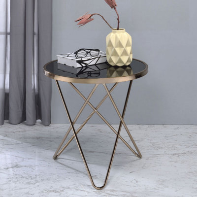 Table ronde avec plateau en verre noir et finition champagne