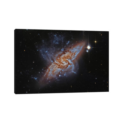 A Pair Of Overlapping Spiral Galaxies (NGC 3314) by Roberto Colombari - Wrapped Canvas Print