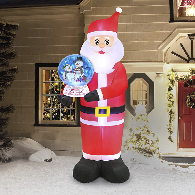 Père Noël tenant une boule à neige gonflable de Noël