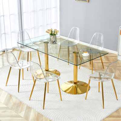 Ensemble de table et de chaises. Table en verre trempé de 71 po x 35,4 po, jumelée à 8 chaises en plastique transparent avec pieds en métal doré. Apportez une expérience confortable à la maison.