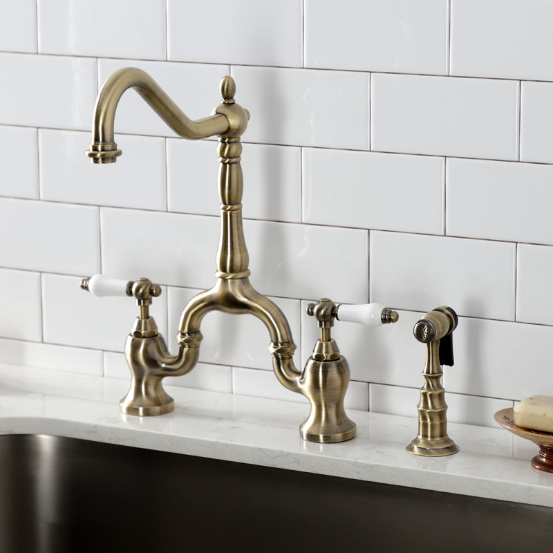 Kingston Brass English Country Two-Handle 3-Hole Deck Mount Bridge Kitchen Faucet with Brass Side Sprayer, Antique Brass