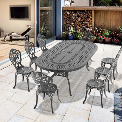 Ensemble de salle à manger 9 pièces en aluminium moulé, structure noire, motifs pétales, revêtement haute température, design ergonomique, siège avec pieds antidérapants.